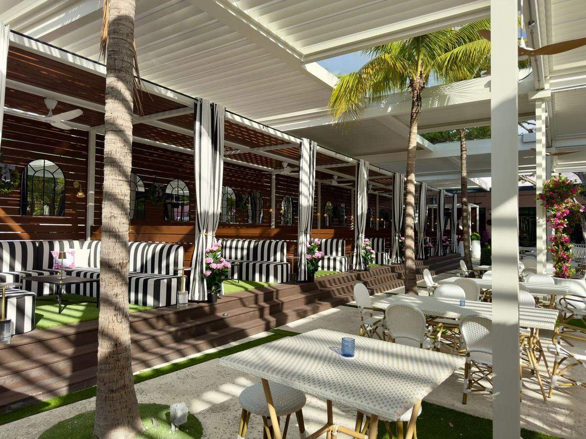 Private VIP cabanas and outdoor tables at Throw Social Miami in Wynwood.