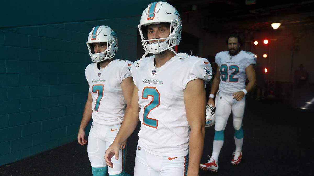 Miami Dolphins punter Matt Haack (2) and kicker Jason Sanders (7) enter the field after a long rain delay in Week 1.