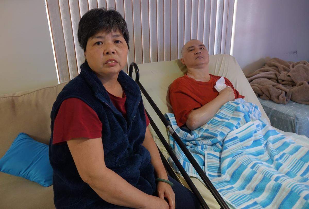 Phuong Ly Cen, 50, sits with her husband, Yue “Alex” Kui Cen, 51, inside their Little Havana home in May 2019. He suffered severe brain damage in a hammer attack in December 2011 in Little Havana in Miami.