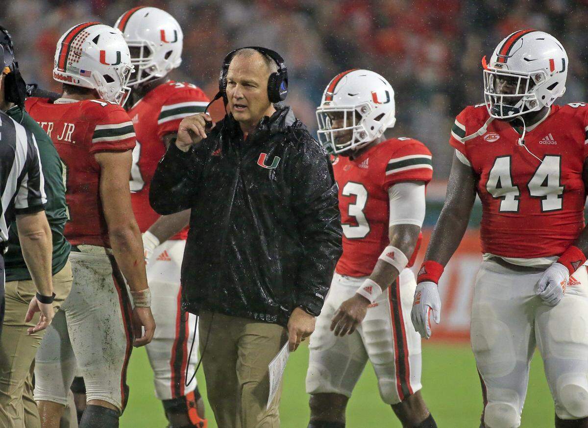 Miami Hurricanes head coach Mark Richt talks to players during timeout in the second quarter as the University of Miami host Duke University at Hard Rock Stadium in Miami Gardens on Saturday, November 3, 2018.