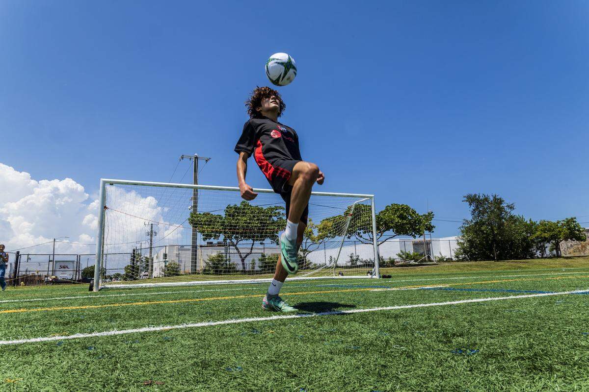 Soccer player Andy Rodriguez practices at the Little Haiti Soccer Park, that is covered with artificial turf at noon where temperatures measured several degrees higher than in the natural turf covered areas, on Tuesday, July 29, 2025.