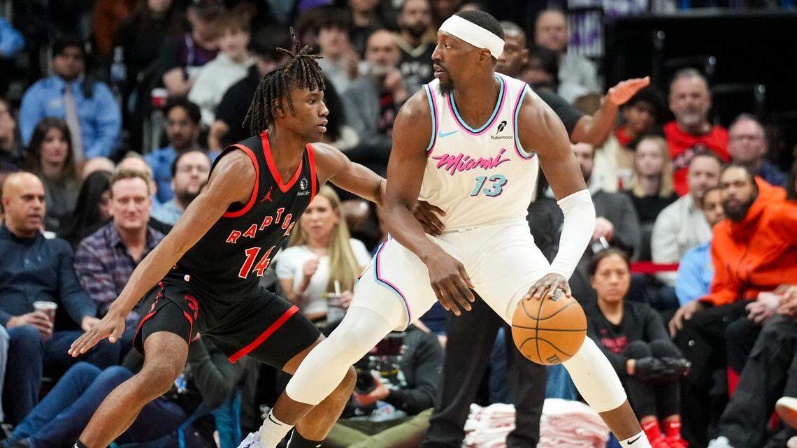 Miami Heat center Bam Adebayo (13) dribbles the ball against Toronto Raptors guard Ja’Kobe Walter (14) during the second half at Scotiabank Arena.