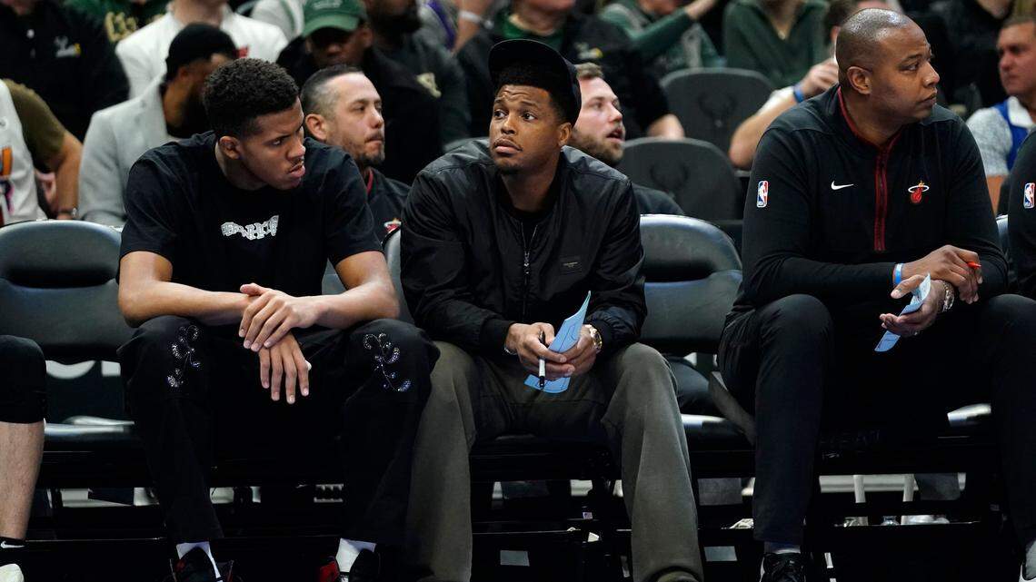Miami Heat’s Kyle Lowry, middle, watches from the bench during the first half of an NBA basketball game against the Milwaukee Bucks Saturday, Feb. 4, 2023, in Milwaukee.