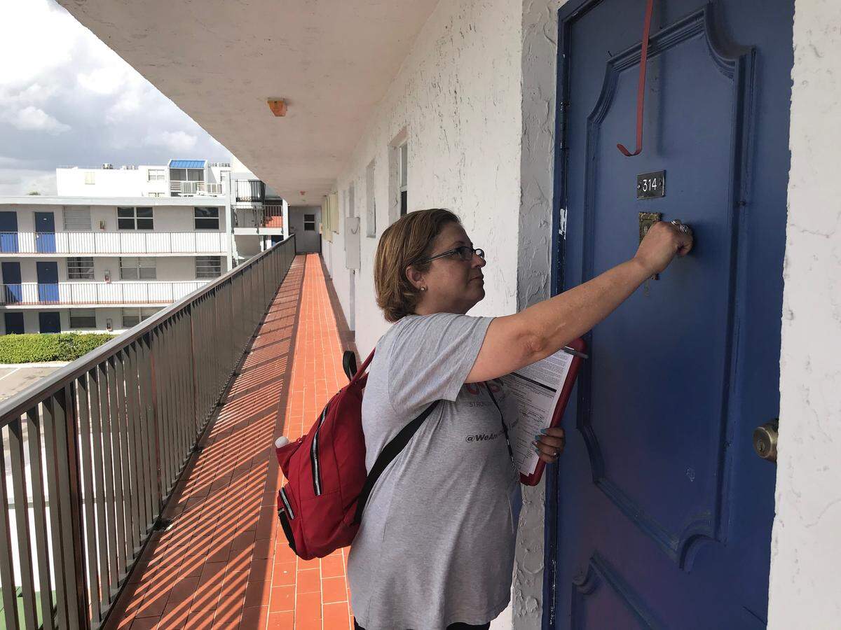 Taira Rodriguez, a canvasser for UnidosUS, knocks on doors at a Kendall apartment building on Friday, Jan. 17, 2020.