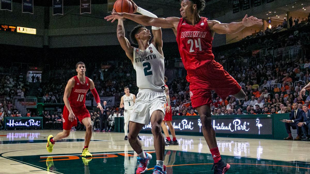 Miami Hurricanes guard Isaiah Wong (2) gets inside the paint as Louisville Cardinals forward Dwayne Sutton (24) defends in the first half as the Miami Hurricanes host the Louisville Cardinals at Watsco Center on Tuesday, November 5, 2019.