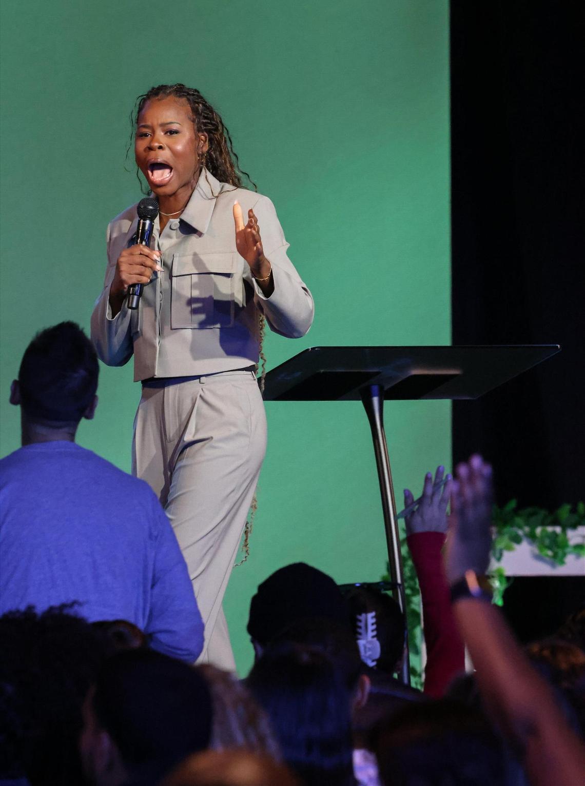 VOUS Pastor Manouchka Charles preaches during Palm Sunday service as congregants worship and give praise in Miami Gardens.