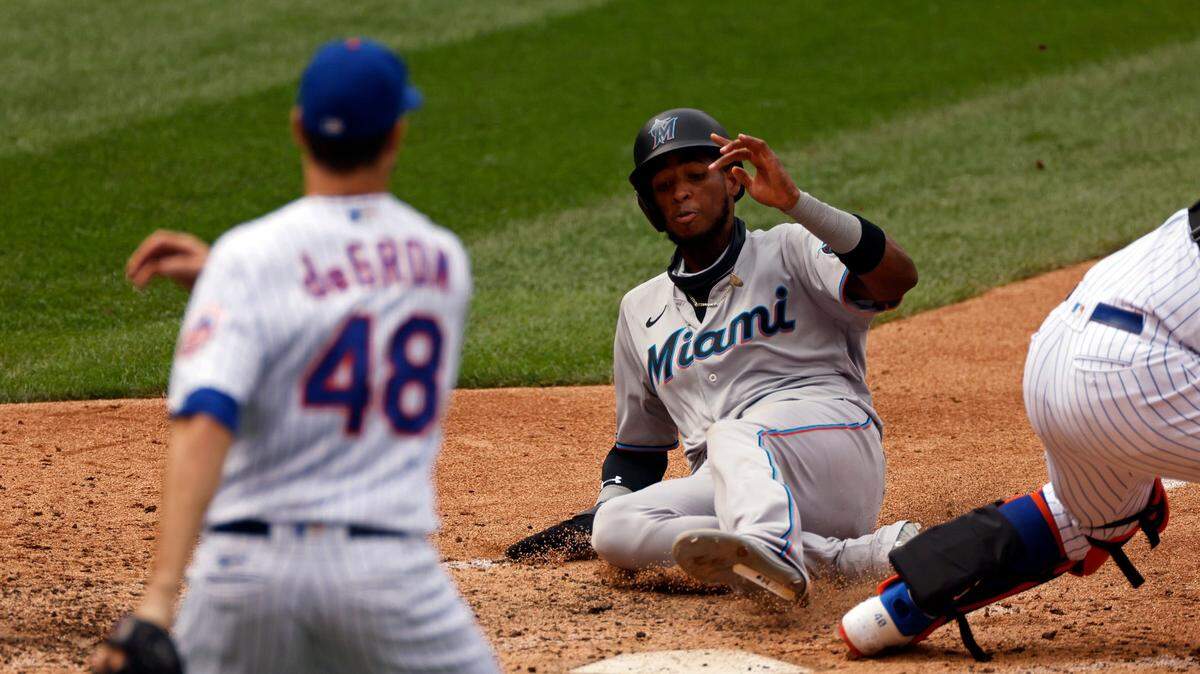Miami Marlins’ Lewin Diaz scores in front of New York Mets pitcher Jacob deGrom (48) during the sixth inning of a baseball game on Monday, Aug. 31, 2020, in New York. (AP Photo/Adam Hunger)