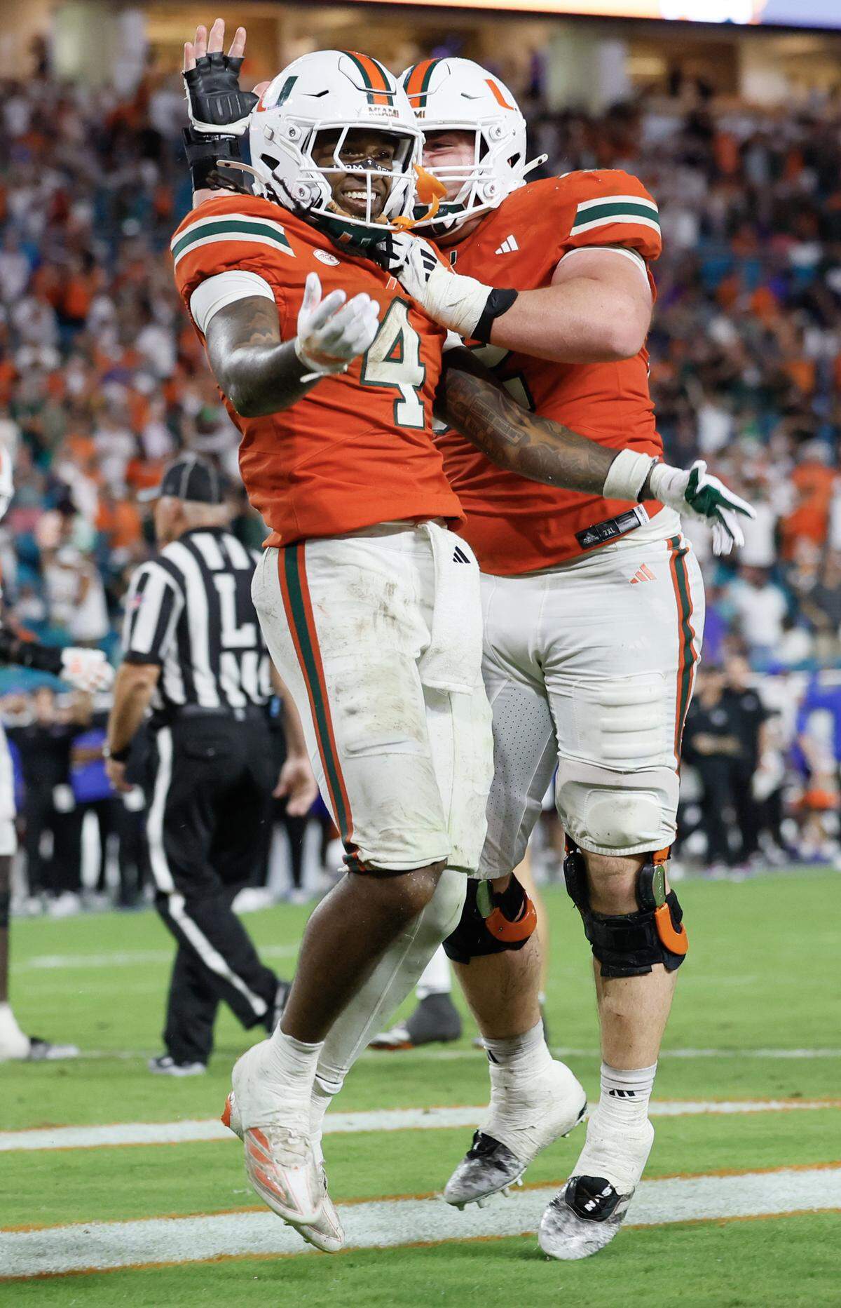 Miami Hurricanes running back Mark Fletcher Jr. (4) celebrates with offensive lineman James Brockermeyer (52) after scoring in the second half of their NCAA football game against the Florida Gators at Hard Rock Stadium in Miami Gardens, Florida, on Saturday, September 20, 2025.