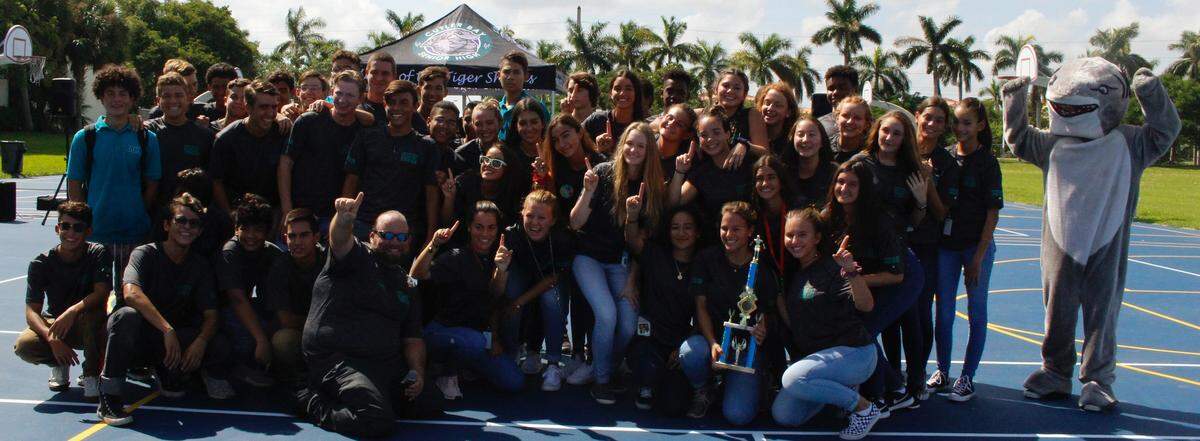 Mary Smutny, Hailey Jerew and Miguel Sierra of Cutler Bay High School’s Swim Team recently competed in The Florida High School Athletic Association’s swim competition and earned top honors. The students are pictured with their teammates, Coach Marshall Ruffo, and school mascot, the Tiger Shark.