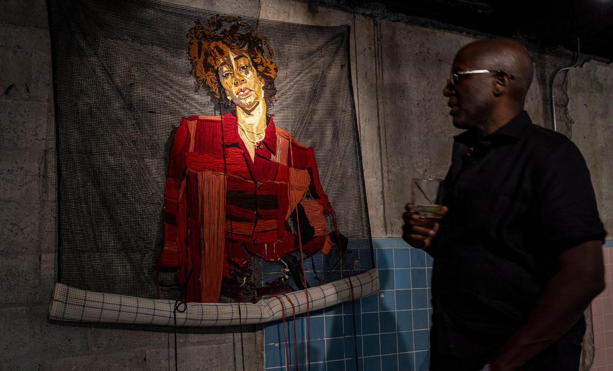 A guest views MELO by artist Kandy G Lopez at the opening of “Gimme Shelter” at the Historic Hampton House, the museum’s first art exhibition.