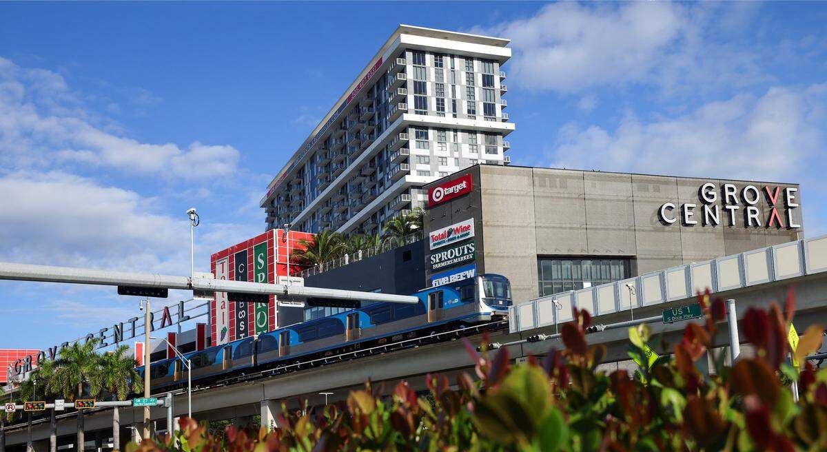 Grove Central is a major mixed-use development located in the heart of Coconut Grove, Miami. Developed by Terra Group and Grass River Property, the project integrates residential apartments, retail, and transit infrastructure into a single, transit-oriented hub. Grove Central features hundreds of rental apartments, a hotel, and prominent retailers such as Target and Sprouts Farmers Market, as well as restaurants and co-working spaces. It is directly connected to the Coconut Grove Metrorail station, making it a key part of Miami-Dade County's push for more sustainable, car-optional urban living. A Metrorail train departs the Coconut Grove Station northbound on Thursday, May 14, 2026, in Miami, Fla.
