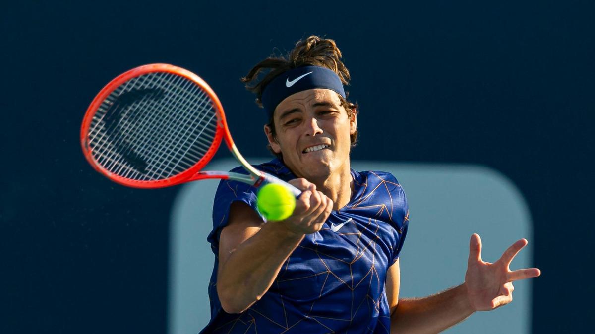 Taylor Fritz, of U.S., returns a shot to Tommy Paul, of U.S., during their match at the Miami Open tennis tournament on Monday, March 28, 2022 at Hard Rock Stadium in Miami Gardens, Florida.