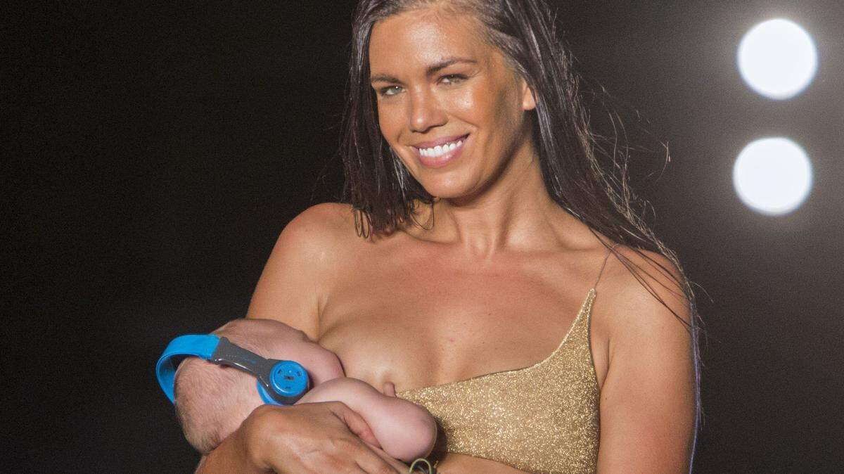 Model Mara Martin walks the runway while breastfeeding her baby for the 2018 Sports Illustrated Swimsuit show at PARAISO during Miami Swim Week at The W Hotel South Beach in Miami Beach on July 15, 2018.