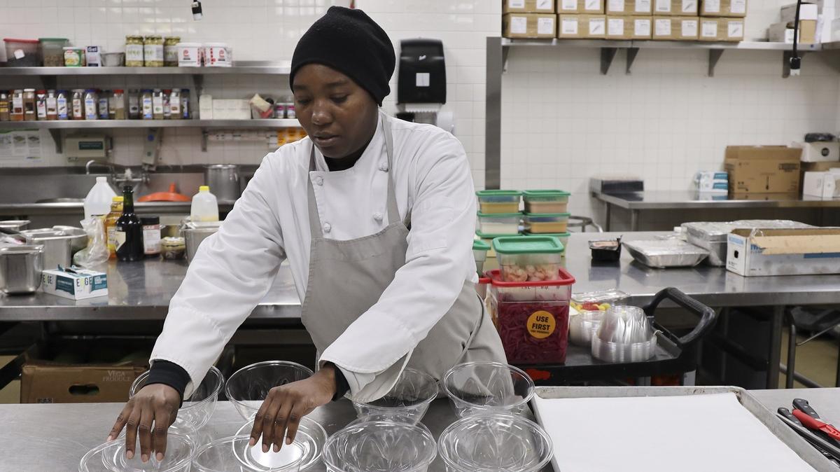 On Monday, November 29, 2019, Michelle Phillips, 33, prepares chicken Caesar salads for the Chez Bon Bon cafe at the Fontainebleau resort in Miami Beach.