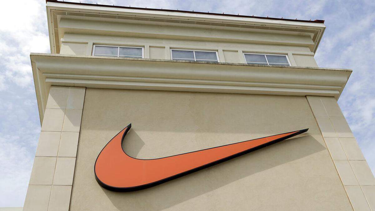 FILE - In this file photo dated Tuesday, Sept. 4, 2018, a Nike company logo is displayed outside a Nike store in Charlotte, N.C. (AP Photo/Chuck Burton, FILE)