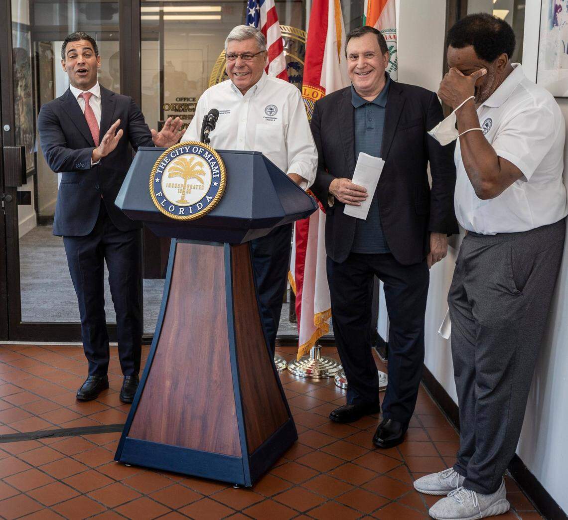 Miami Mayor Francis Suarez, left, kids with Commissioner Manolo Reyes, second from the left, during a press conference where he announced a spending plan for $137 million in federal pandemic relief on Sept. 14, 2021. Also in the photo are Commissioner Joe Carollo, second from right, and Commissioner Jeffrey Watson, on the far right.