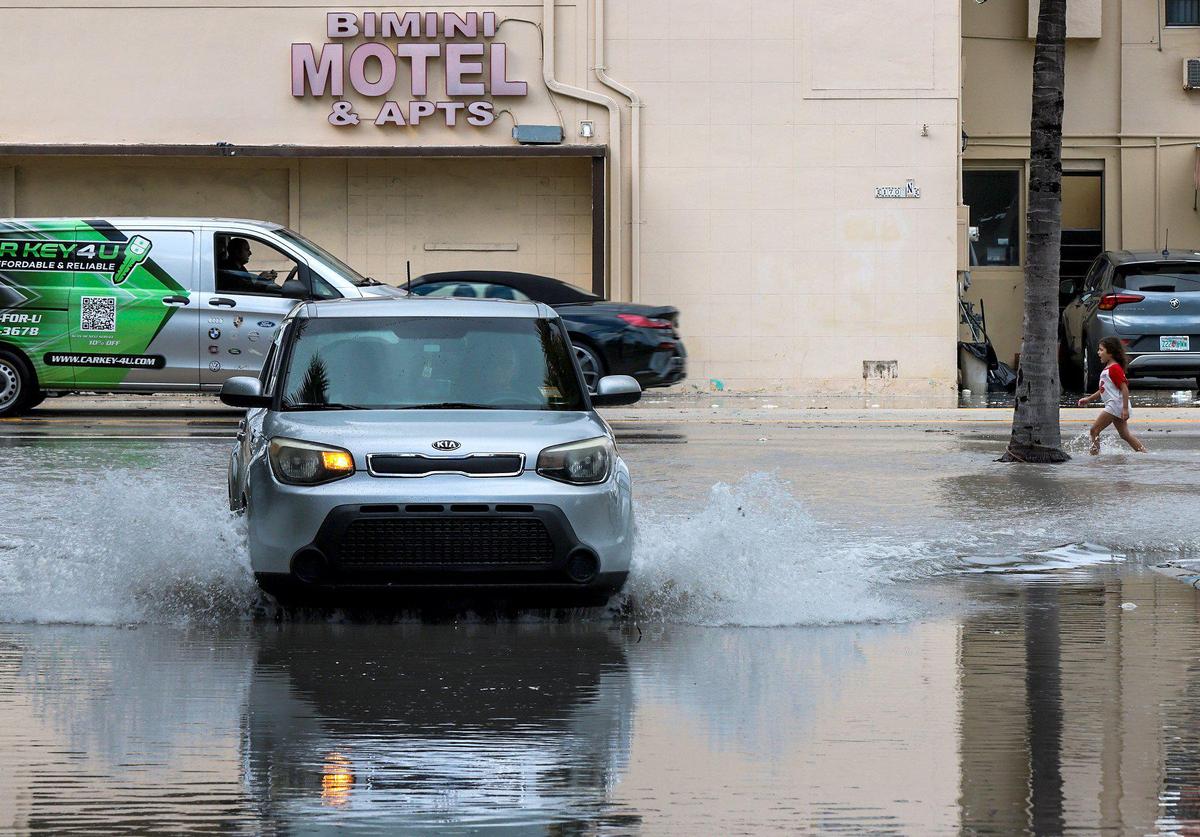 Motorists and pedestrians navigate the flooded streets of Hollywood Beach. On Thursday, Nov. 10, 2022, the City of Hollywood, business owners, visitors, and residents began cleaning up after Hurricane Nicole caused flooding, sand intrusion and erosion, and made a total mess of the Hollywood Beach Broadwalk.