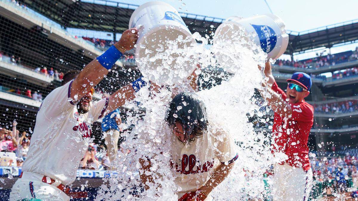 Philadelphia Phillies’ Bryson Stott, center, gets doused by his teammates after hitting a three-run home run following the ninth inning of a baseball game against the Miami Marlins, Wednesday, June 15, 2022, in Philadelphia. The Phillies won 3-1. (AP Photo/Chris Szagola)