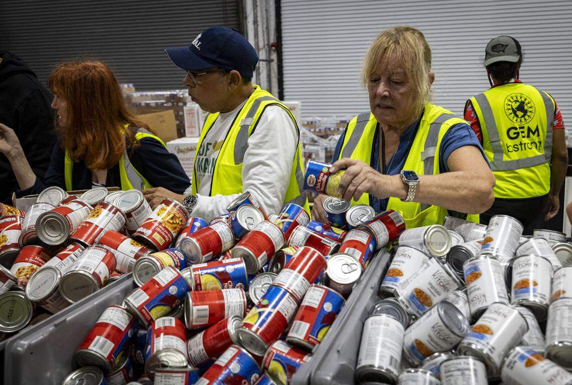 Volunteer Terry Springer, right, prepare care packages for Jamaica at Global Empowerment Mission in Doral. The donations will head to the island after Hurricane Melissa passes.