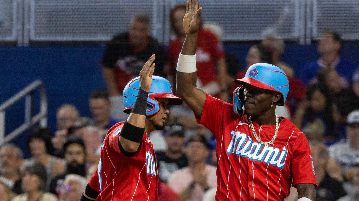 Miami Marlins center fielder Jazz Chisholm Jr. (2) and second baseman Luis Arraez (3) celebrate after scoring against the Chicago Cubs after right fielder Jesus Sanchez (7) hit a ground-rule double on a line drive to left field against the Chicago Cubs in the first inning of an MLB game at loanDepot park on Saturday, April 29, 2023, in Miami, Fla.