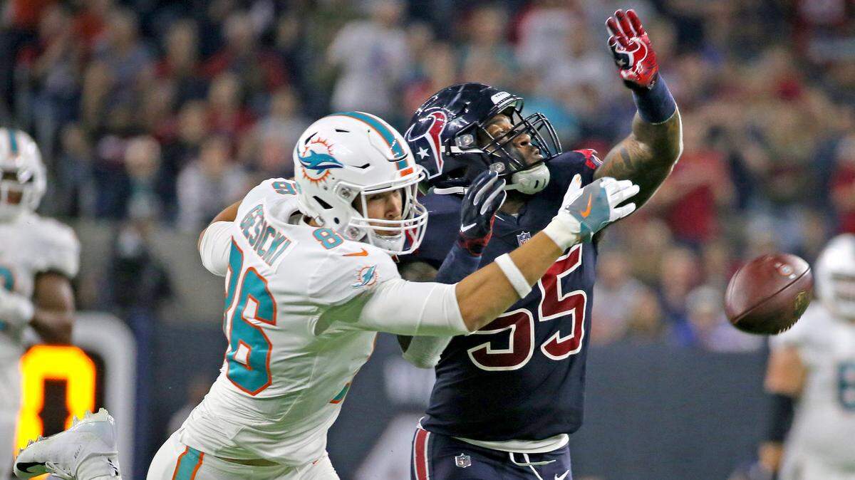 Miami Dolphins tight end Mike Gesicki can’t reach the ball as Houston Texans Benardrick McKinney defends in the second quarter at NRG Stadium in Houston, Texas, Thursday, October, 25, 2018.