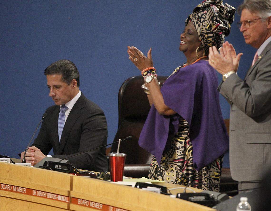 School board members Dr. Dorothy Bendross-Mindingall and Dr. Lawrence S. Feldman lead a standing ovation as Alberto Carvalho, superintendent of Miami-Dade County Public Schools, announced his decision to stay in Miami-Dade instead of going to New York City during a packed School Board meeting on Thursday, March 1, 2018.