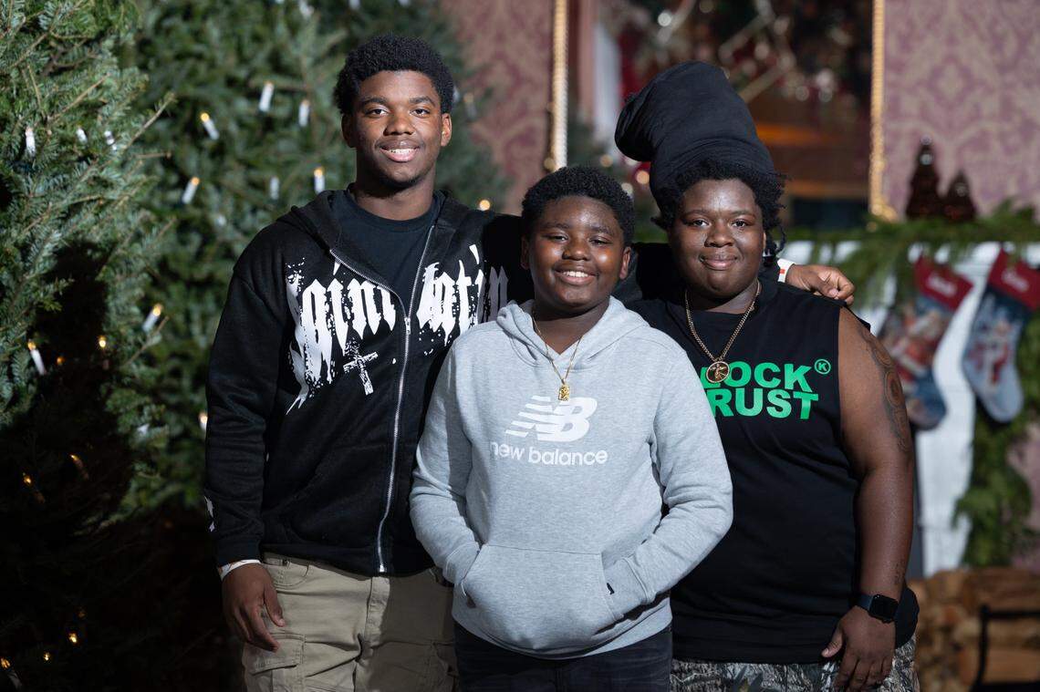 From left: Zion Chery, Sir-Isaac Moore, and Bryanna Carter pose for Christmas photo taken in 2023.
