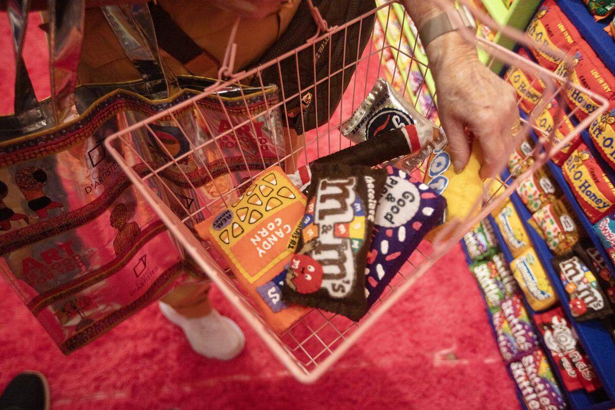 (Center) Dorothy Koreman shops art from "Sugar Rush" at ART MIAMI in MIami on Tuesday December 2nd., 2025.