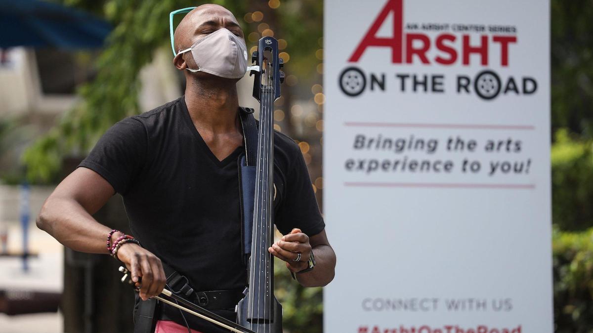 Cellist Guy Michel, left, gives a midday performance at Alamo Park as Arsht Center launched its new “Arsht on the Road” series of pop-up performances throughout the county on Wednesday, October 28, 2020.