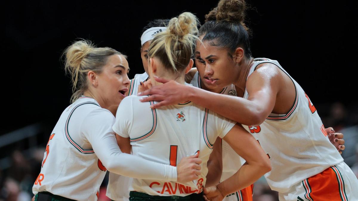 Miami Hurricanes forward Cameron Williams (right) talks to Miami Hurricanes guard Hanna Cavinder (left), and guard Haley Cavinder (center) against the Charlotte 49ers during the first quarter at Watsco Center in Coral Gables, Florida, Friday, November 29, 2024.
