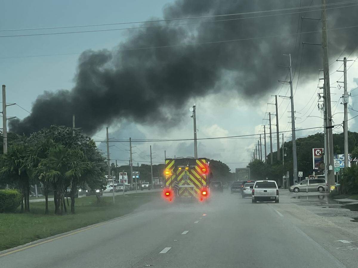 A Key Largo Fire Department truck drives on U.S. 1 toward a house where a boat was on fire Tuesday, Sept. 23, 2025.