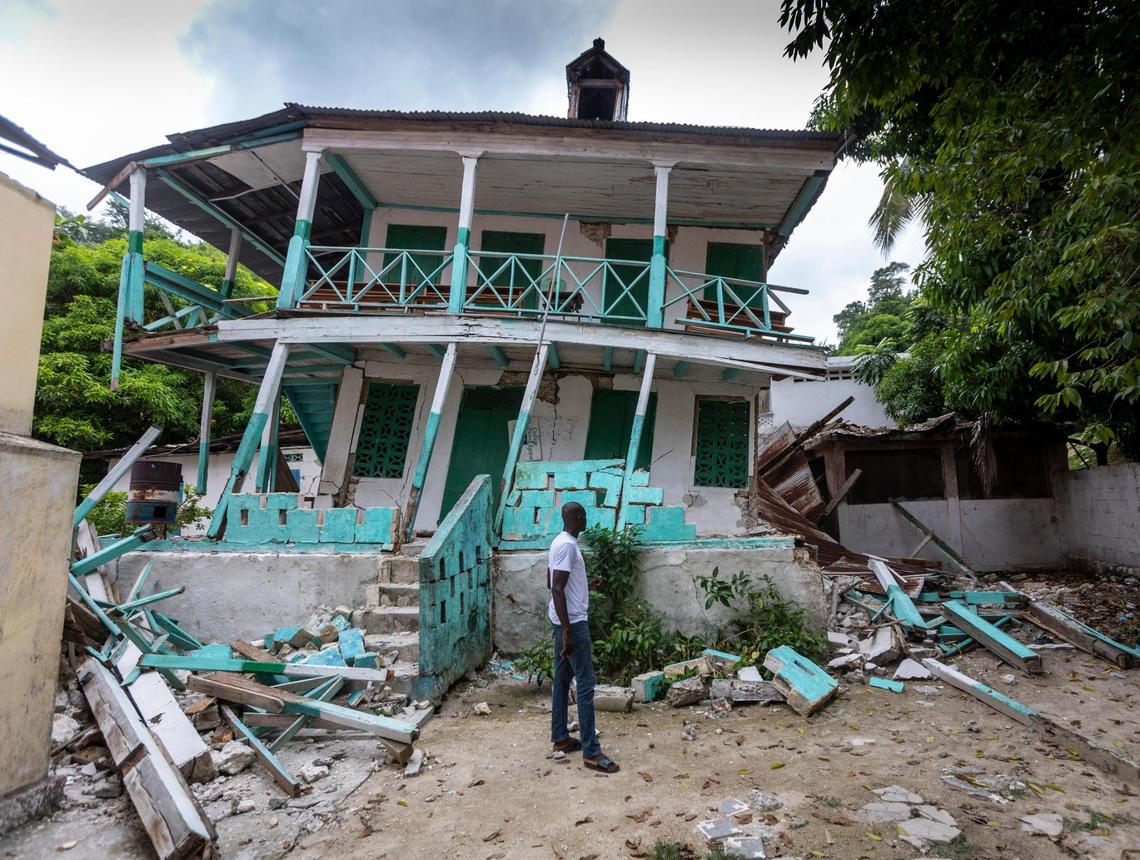A man stands in front of a damaged school in Corail, Haiti, in the Grand’Anse region. Many structures in this small fishing village were damaged or destroyed by the August 2021 earthquake.