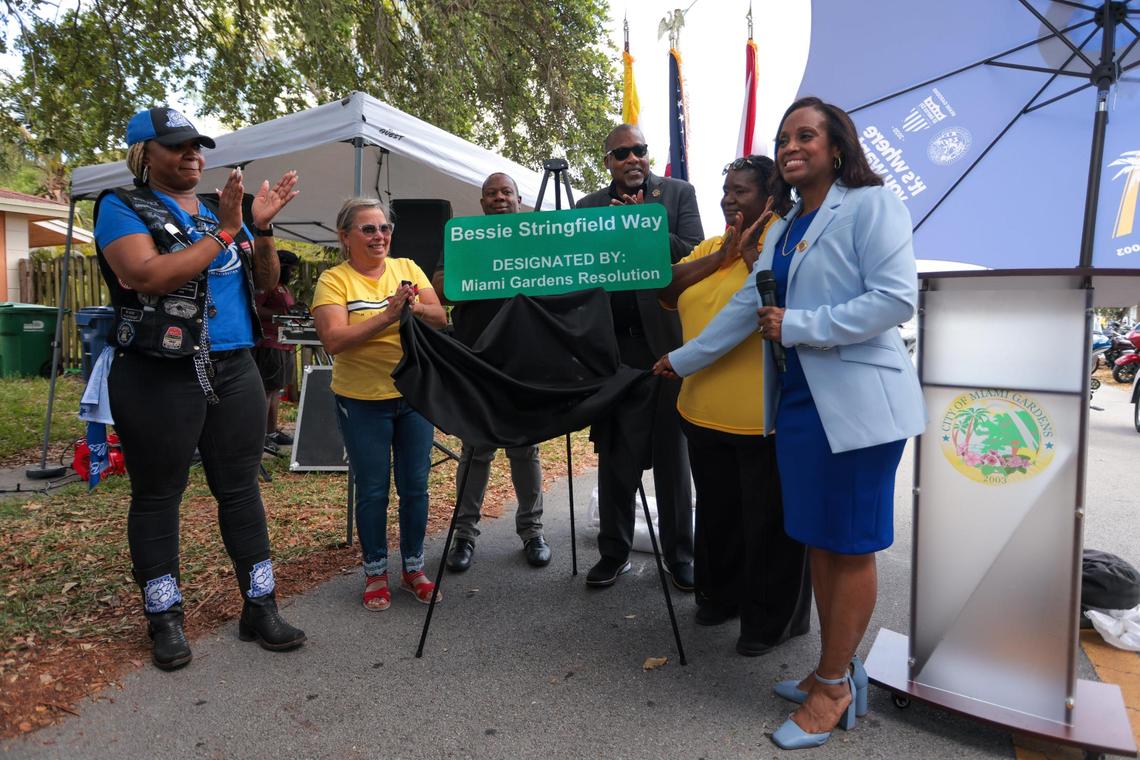 Miami Gardens Councilwoman Michelle Powell, right, joined by mayor Rodney Harris and councilman Reggie Leon, along with Tameka Singleton (left) unveil the new sign honoring motor cycle legend Bessie Stringfield.