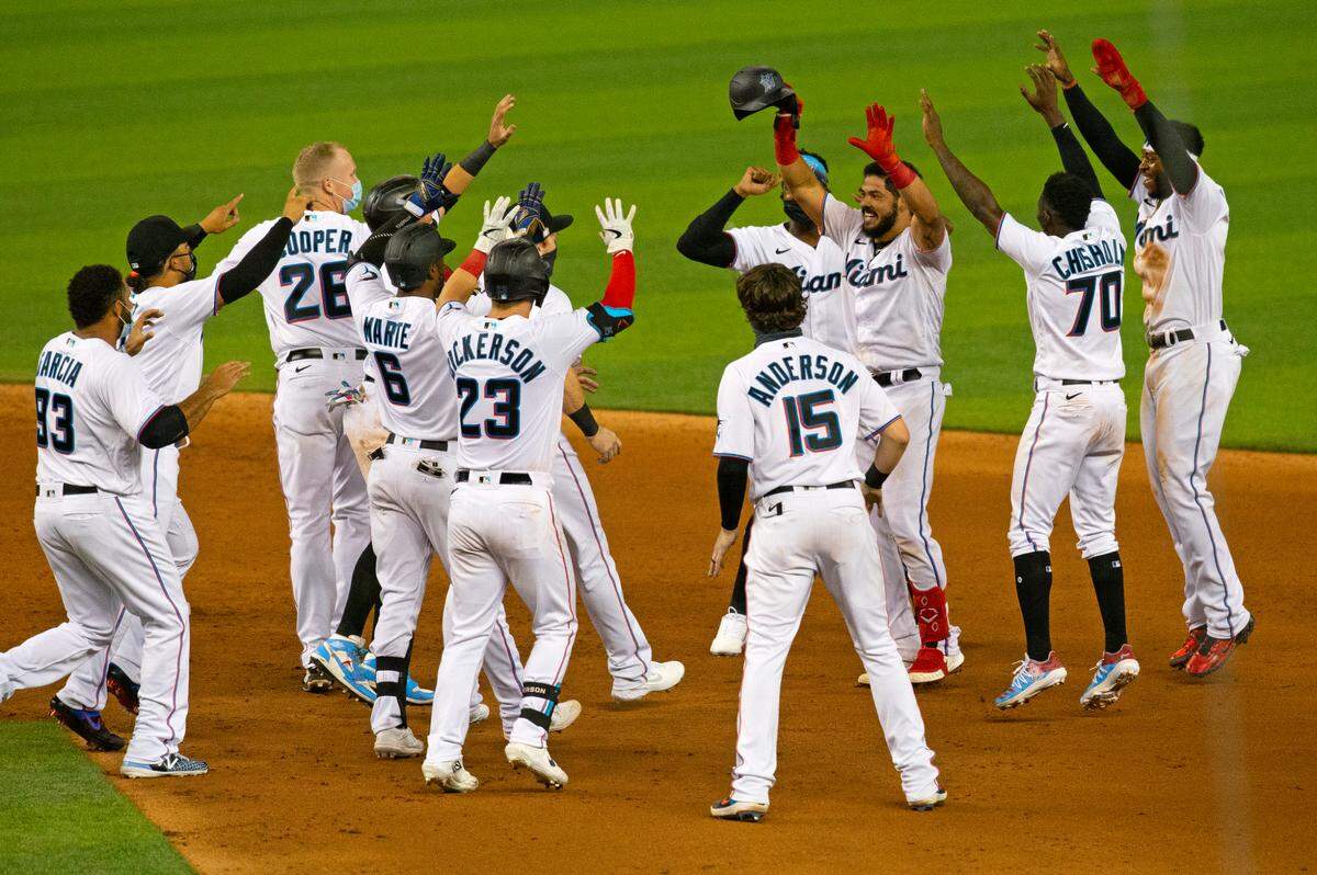 Miami Marlins catcher Jorge Alfaro (38) celebrate with teammates after hitting a walk-off RBI single in the ninth inning of a baseball game against the Philadelphia Phillies at at Marlins Park in Miami on Thursday, September 10, 2020. Marlins won 7-6.