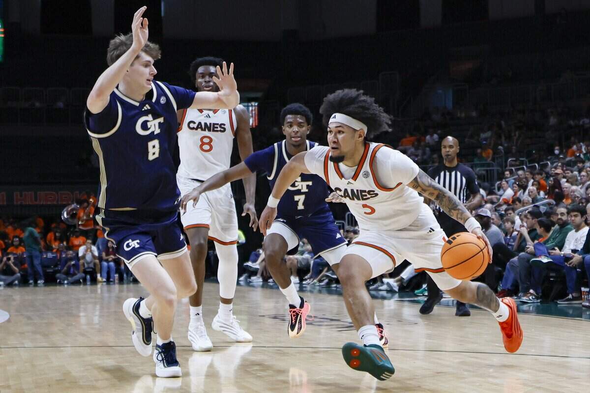 Miami Hurricanes guard Tre Donaldson (3) drives the ball as Georgia Tech Yellow Jackets center Cole Kirouac (8) defends during the second half of an NCAA basketball game at the Watsco Center on the University of Miami Campus on Saturday, January 10, 2026 in Coral Gables, Florida.
