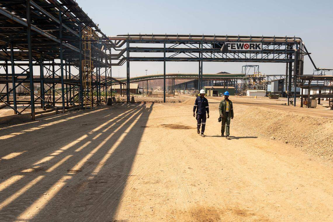 Workers walk in the copper-cobalt Mutanda Mine, owned by Anglo-Swiss firm Glencore, in southeastern Democratic Republic of Congo, on June 19, 2023. (Photo by EMMET LIVINGSTONE/AFP via Getty Images)