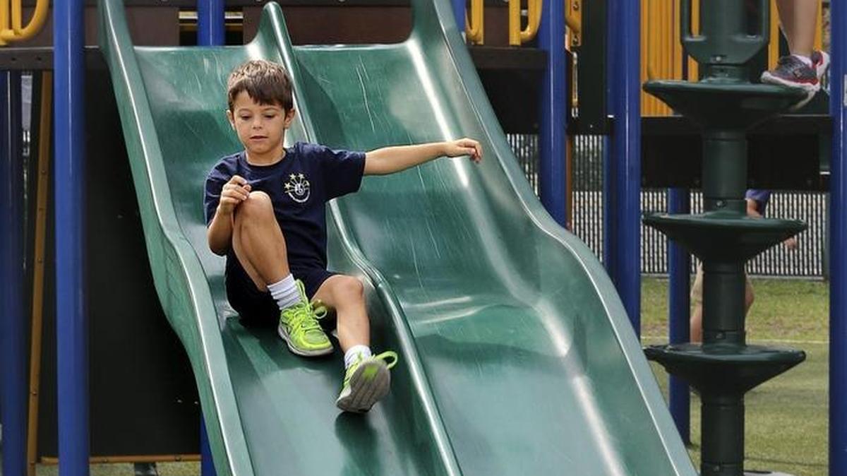 Eric Pedrosa, 6, zooms down the slide during recess at North Beach Elementary's Jennifer Beth Turken Playground in March at the Miami Beach school. Eric and fellow second-graders in Jessica Jiminez's class have two 20-minute recesses per week and a 30-minute PE class Monday through Friday.