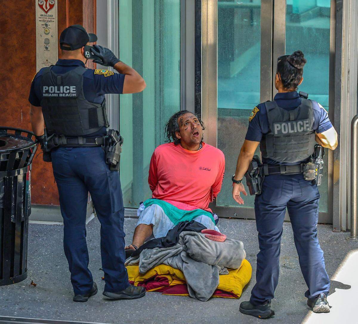 Miami Beach police officers talk to a homeless person on Lincoln Road a couple of hours after Florida Gov. Ron DeSantis signed HB 1365 “to keep Florida’s streets safe” on Tuesday, March 20, 2024.