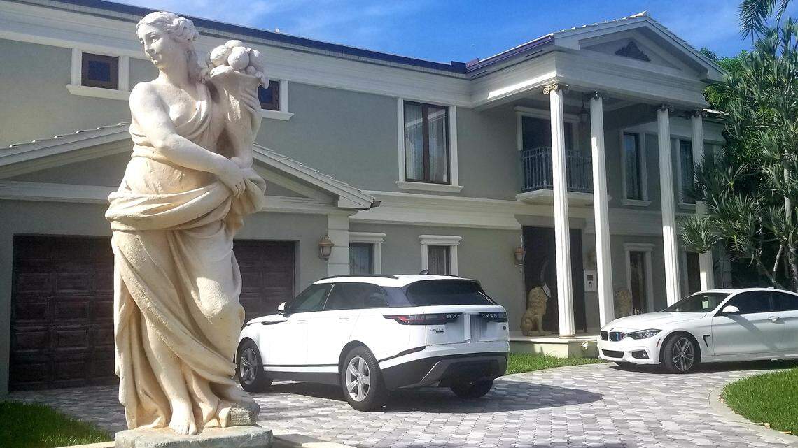 Oleg Firer’s Eastern Shores home with one of its four classical lawn statues. The $2.1 million home as estimated by Zillow looks much like it did when it was owned by famed real-estate fraudsters Victor and Natalia Wolf.