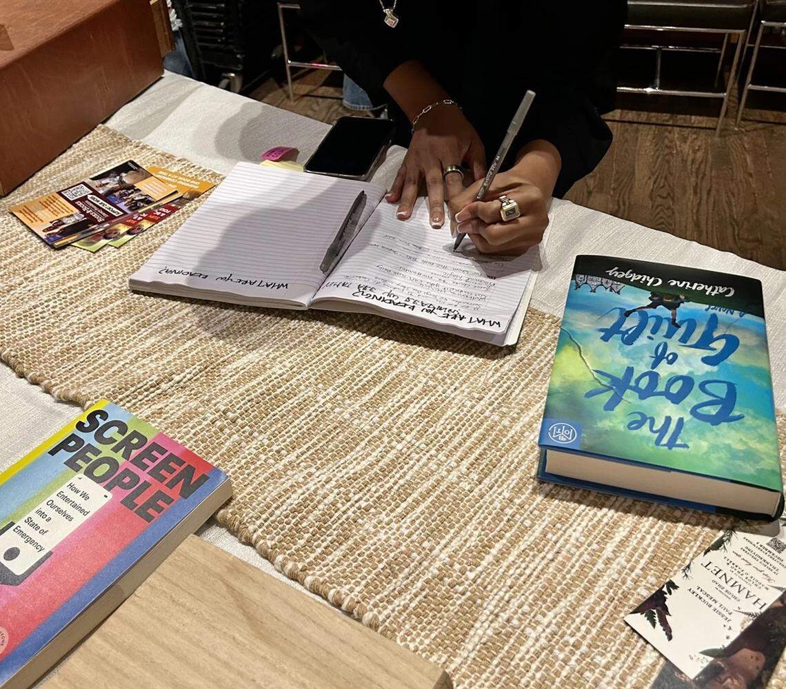 A reading party participant writes down the book they will be reading on Jan. 28.