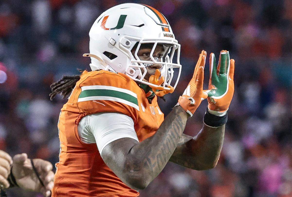 Miami Hurricanes running back Mark Fletcher Jr. (4) flashes the U after scoring in the first quarter against the Louisville Cardinals during their NCAA football game at Hard Rock Stadium in Miami Gardens, Florida, on Friday, October 17, 2025.