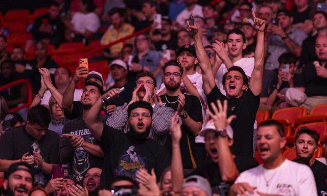 Fans cheer as Kevin Holland of the United States and Randy Brown of Jamaica fight in their welterweight bout at UFC 327 at the Kaseya Center on Saturday, April 11, 2026, in downtown Miami, Fla.