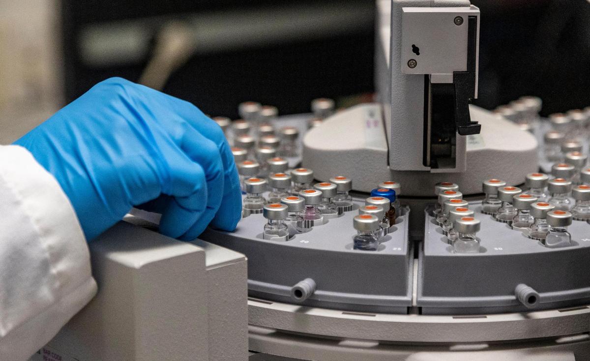 A technician works on one of the gas chromatograph mass spectometers at the Miami-Dade Police Lab on April 15, 2022. MDPD forensics, which does work for all the police departments in the county, has a shortage of helium because of the Russian invasion of Ukraine and other factors.