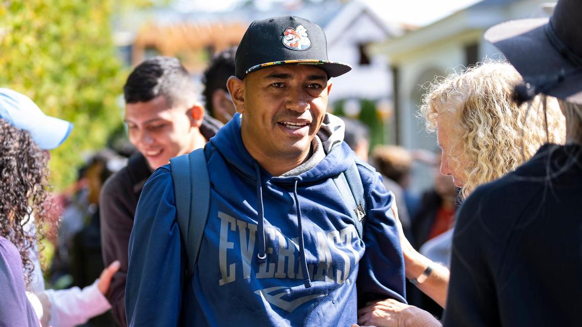 A Venezuelan migrant is led onto a bus at St. Andrews Episcopal Church on Friday, Sept. 16, 2022, in Edgartown, Mass., on the island of Martha’s Vineyard. A group of 48 migrants was flown to the island from Texas earlier this week, leaving them stranded. They are now being transferred to a military base in Cape Cod.