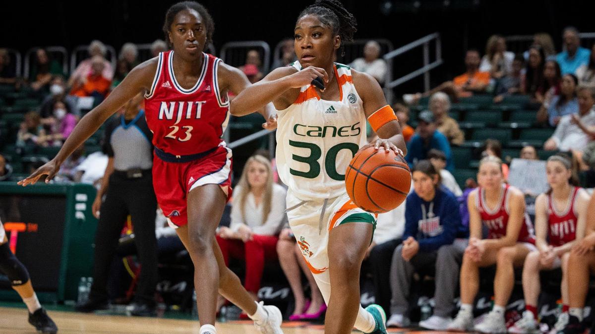 Miami Hurricanes Shayeann Day-Wilson(30) dribbles passed NJIT’s Mackenzie Wright-Rawls (23) during the first quarter of a game on Sunday, Dec. 3, 2023, at the Watsco Center in Coral Gables.