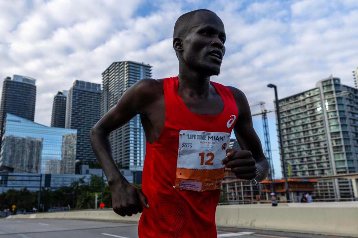 Paul Eyanae, 38, crosses South Miami Avenue bridge as he participates in the 23rd annual Life Time Miami Marathon along with thousands of runners on Sunday, February 2, 2025, in Miami, Fla. Eyanae crossed the finish line first with a time of 2:20:00.
