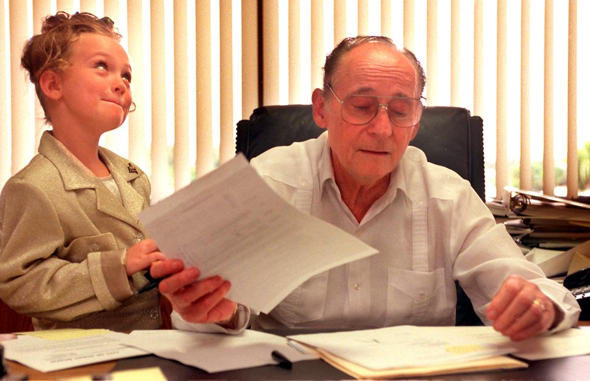 Athena Masson, 7, won the honor of being Mayor of Miami Beach for the day in 1996, so as Mayor Seymour Gelber signed his name, Masson gave her opinion, and asked questions, too. She won the honor when Gelber donated the day following a fundraiser for the Cushman School.
