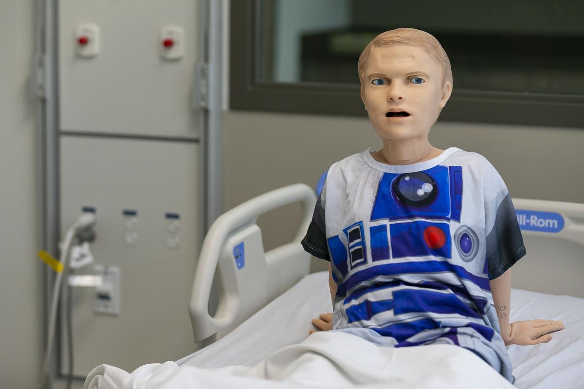 HAL, a medical mannequin, cries during a simulated checkup by Shanti Fernandez at the Miami Dade College Medical Campus on Monday. The college unveiled its $56 million Center for Learning, Innovation and Simulation on Tuesday.