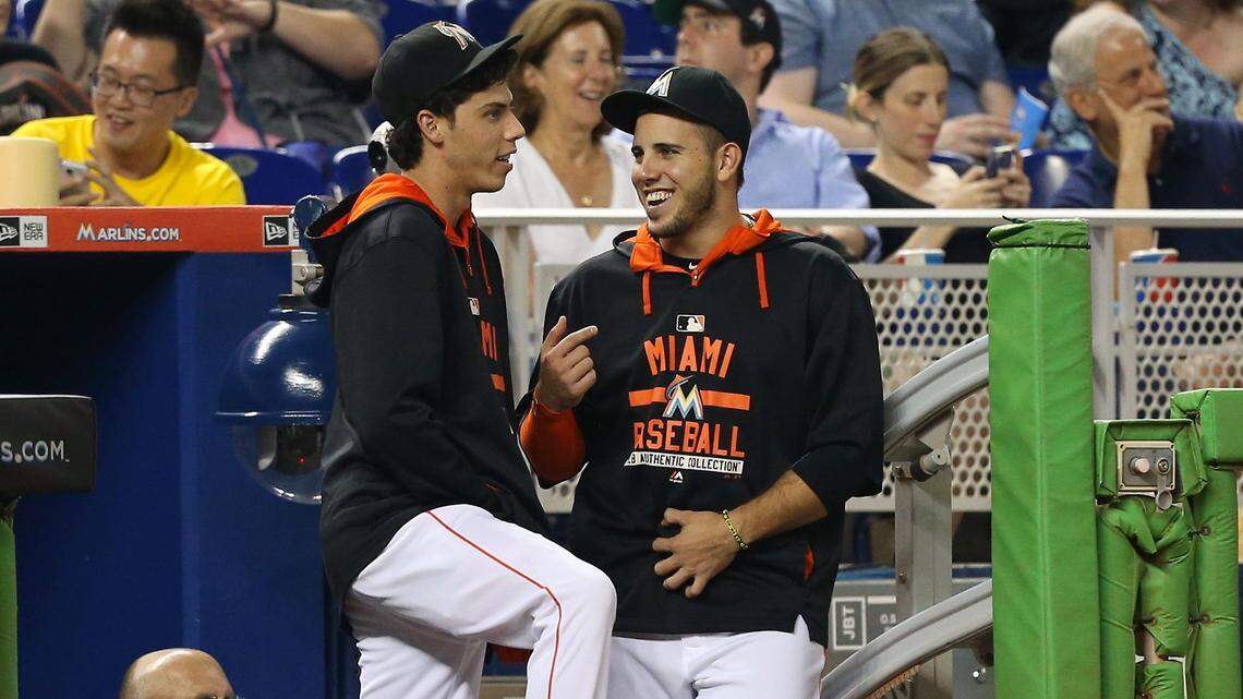 (From left to right) Christian Yelich, of the Miami Marlins talks with teammate Jose Fernandez in the second inning of a baseball game against the Philadelphia Phillies on Thursday, August 20, 2015, at Marlins Park in Miami.