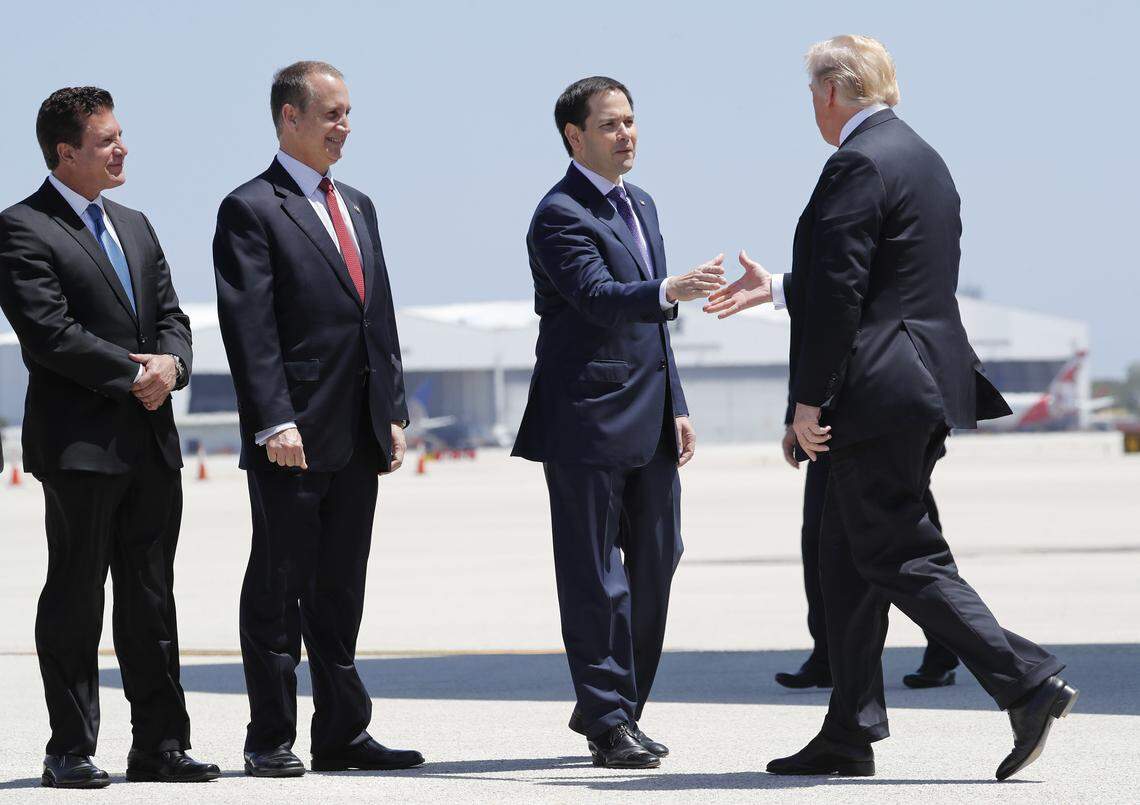 President Donald Trump is greeted by Sen. Marco Rubio, R-Fla., as Hialeah Mayor Carlos Hernandez, left, and Rep. Mario Diaz-Balart, R-Fla., look on during Trump’s arrival on Air Force One at Miami International Airport, Monday, April 16, 2018. Miami-Dade Mayor Carlos Gimenez had wanted to join the welcoming party, but he was not invited.